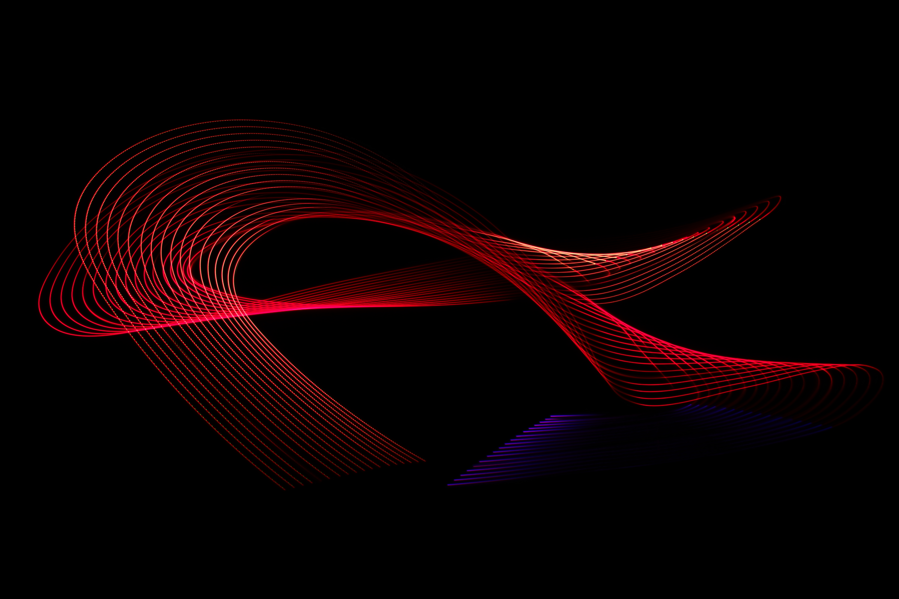 Mainly red streams of light entangled with one violet end